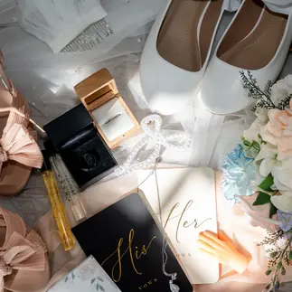 Wedding flat lay with shoes, invitation, rings, and bridal accessories