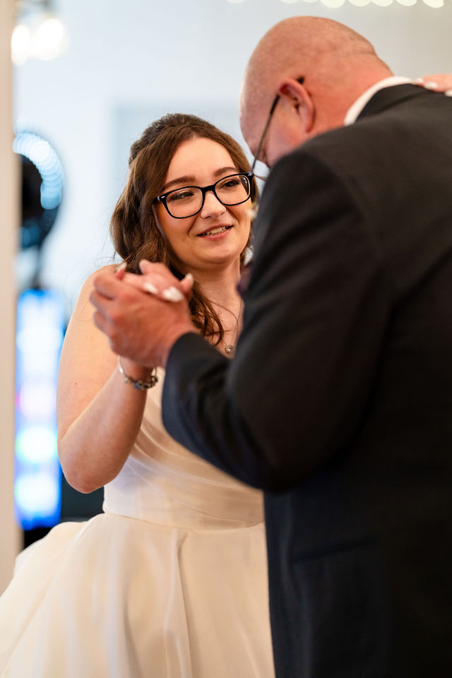 Bride smiling during a dance with her father