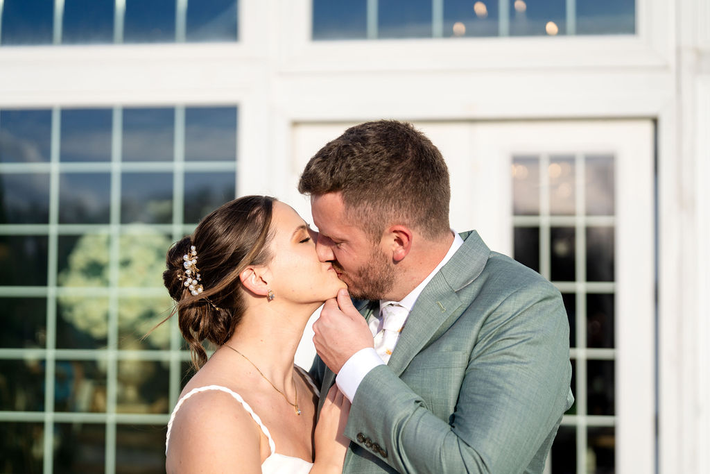 Bride and groom kissing outside their wedding venue