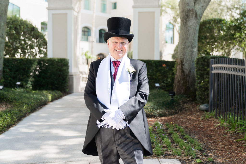 Bride’s father dressed in a top hat waiting outdoors for the first look