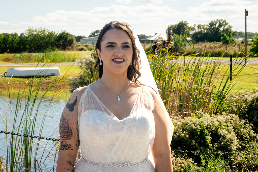 Bride standing beside a pond and fountain