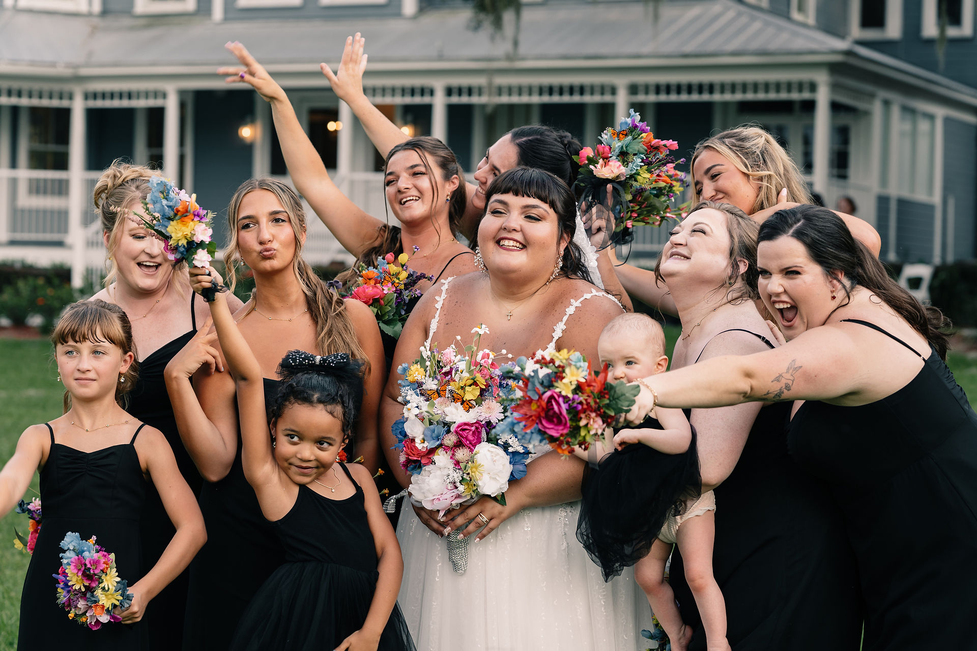 Bride and her bridesmaids all celebrating in a fun group shot at Highland Manor in Orlando, Florida. Photo by Pixel Groves.