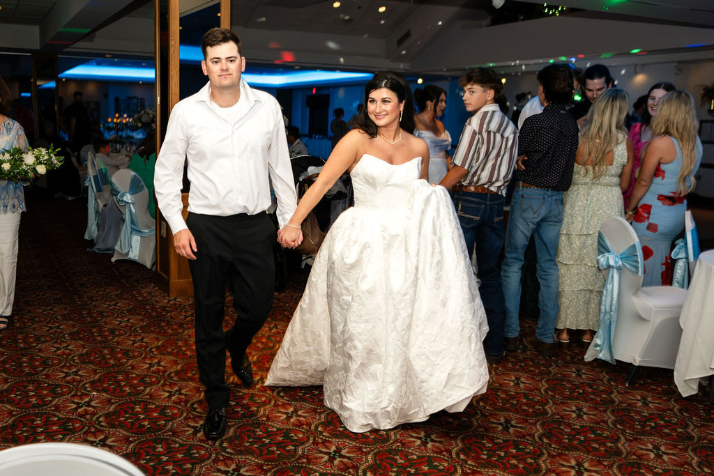 Bride and groom dancing among guests at their wedding reception