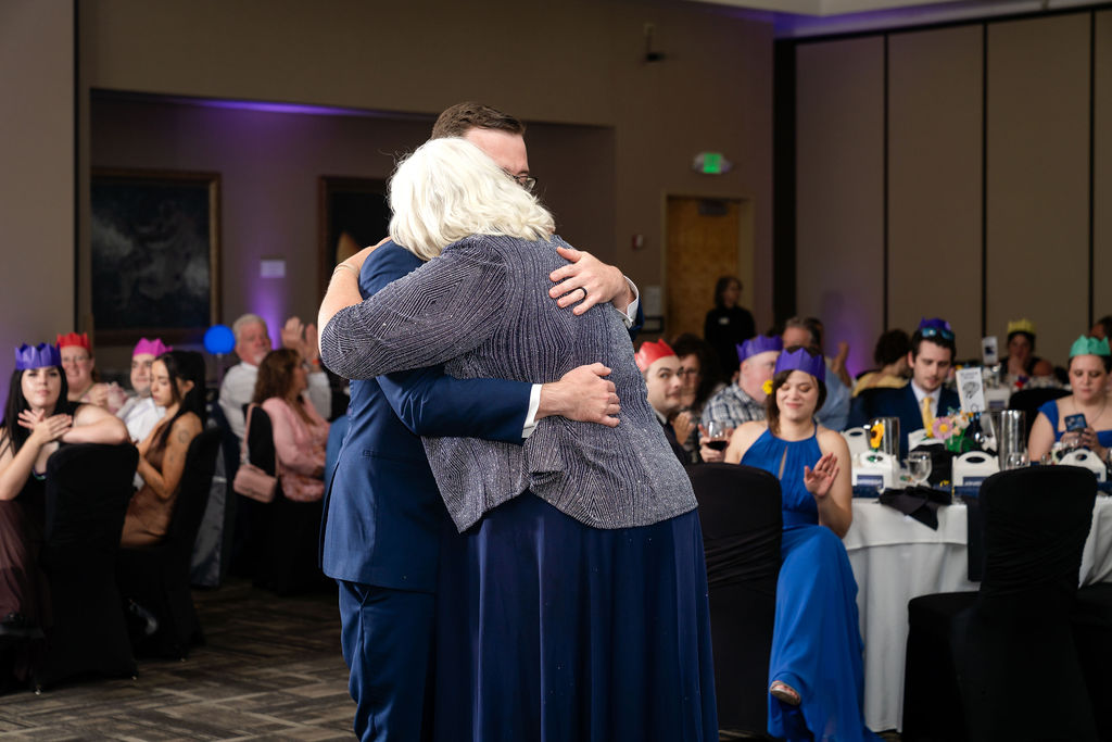 Groom embracing a woman during a family dance