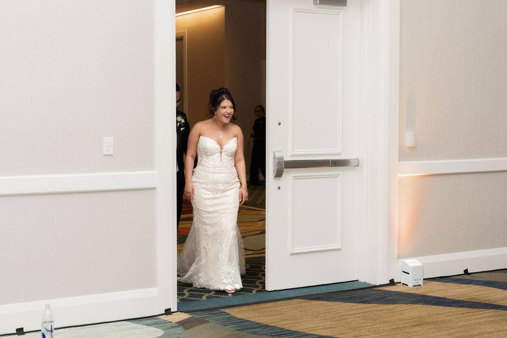 Bride entering the reception through a large doorway