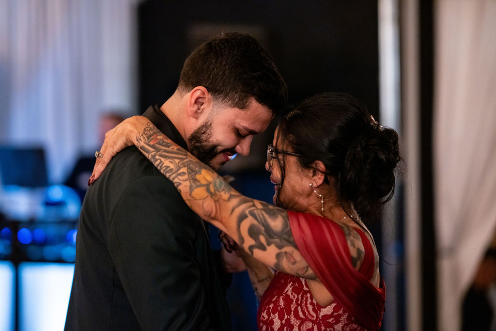 Groom sharing an emotional dance with an older loved one