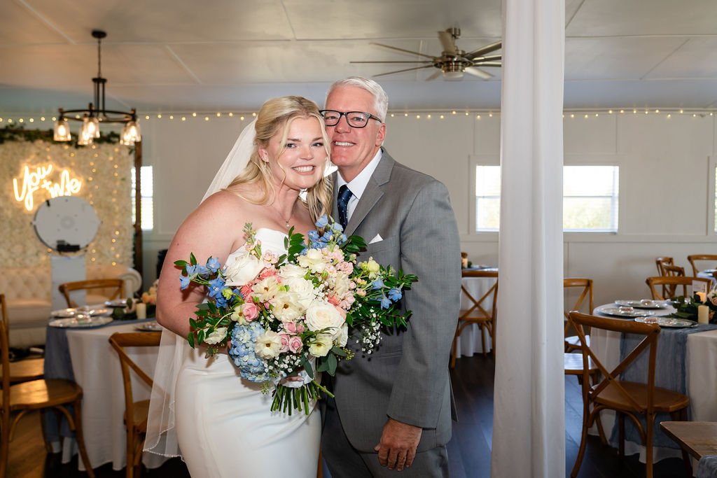 Bride smiling with her father after their first look