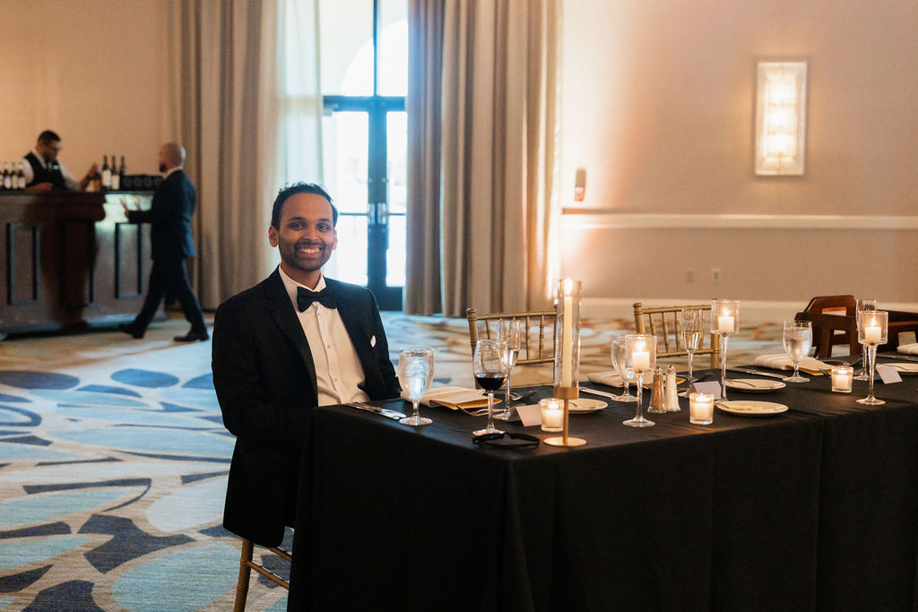 Adult guest seated at a formal wedding reception table