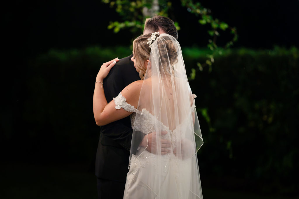 Close view of the bride’s veil during an outdoor evening dance