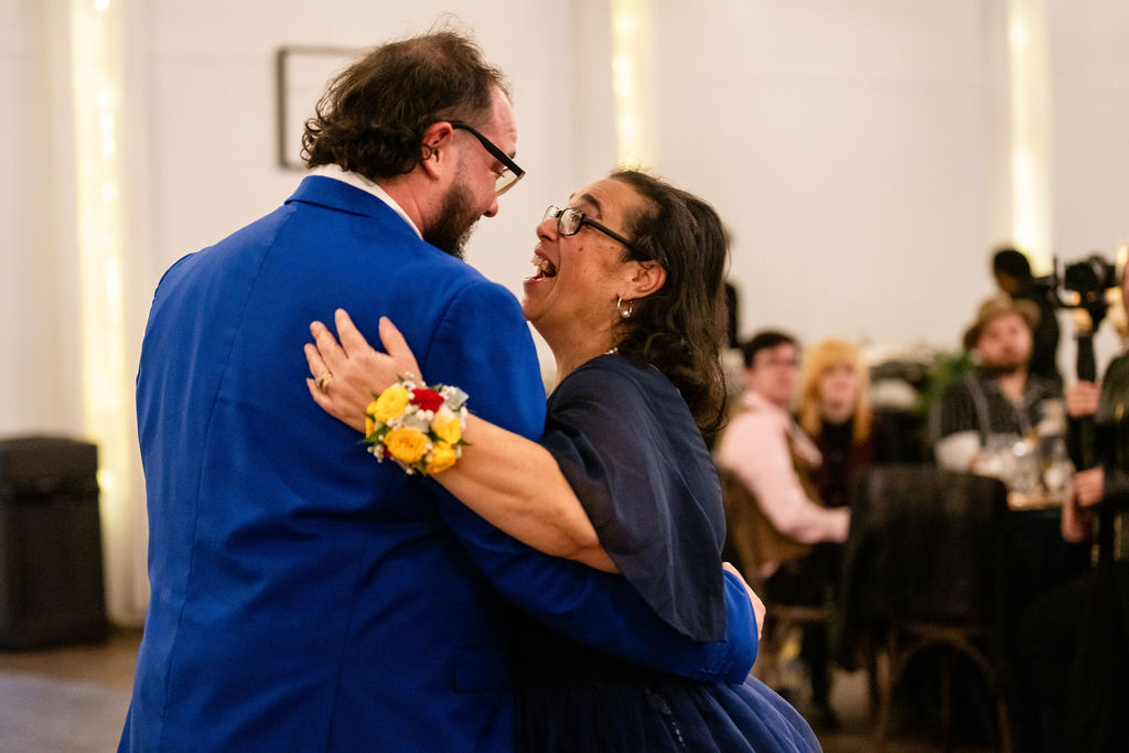 Groom dancing with a woman during a family dance