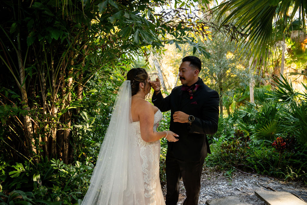Bride and groom meeting for their first look in a palm garden