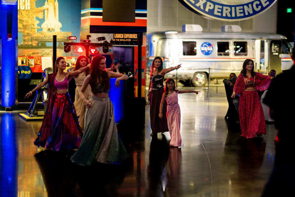 Women performing a coordinated dance at the wedding reception