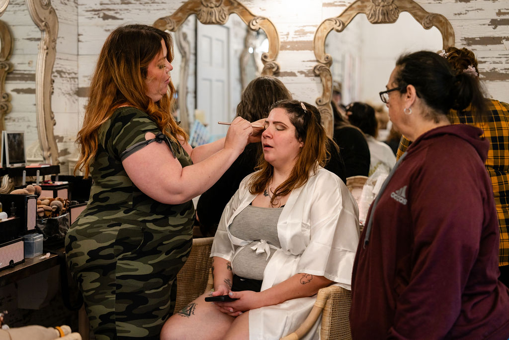 Makeup artist working with the bride before the wedding