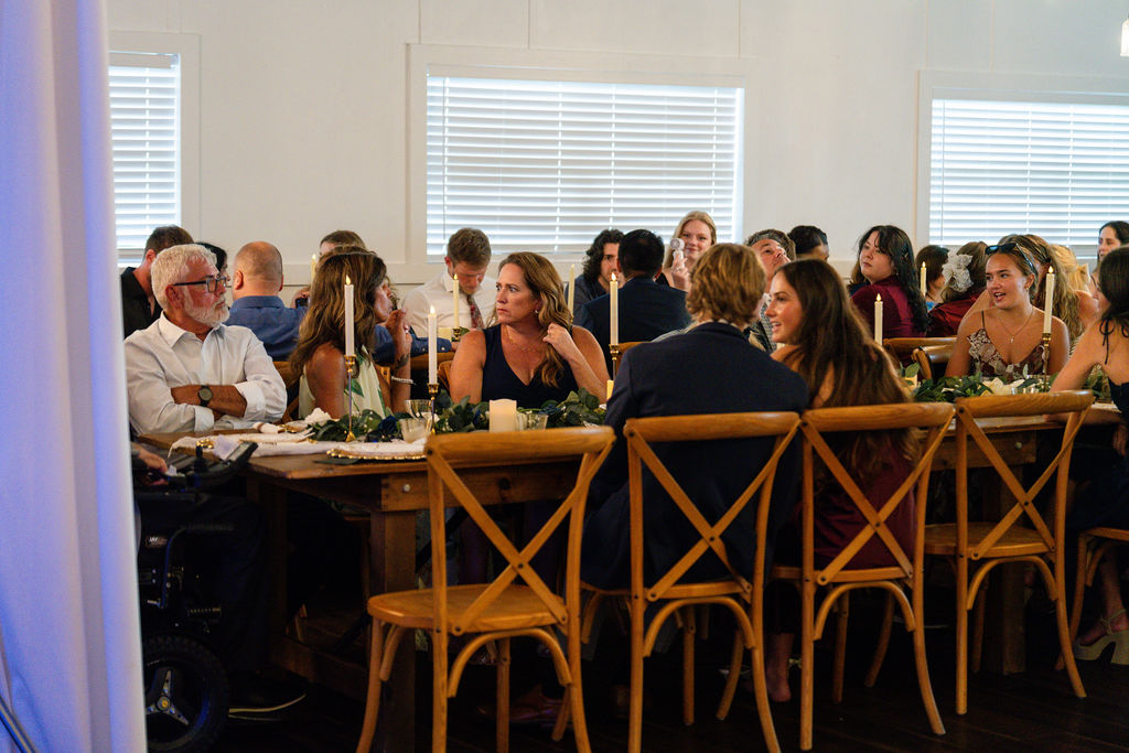 Wedding guests seated at decorated reception tables