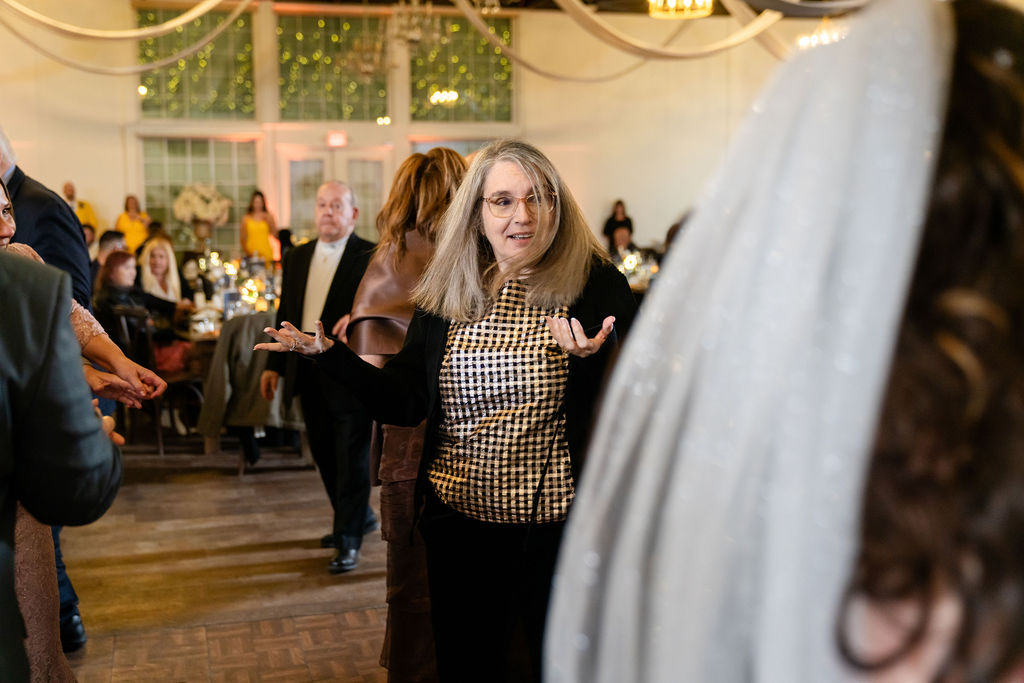 Adult wedding guest dancing at the reception