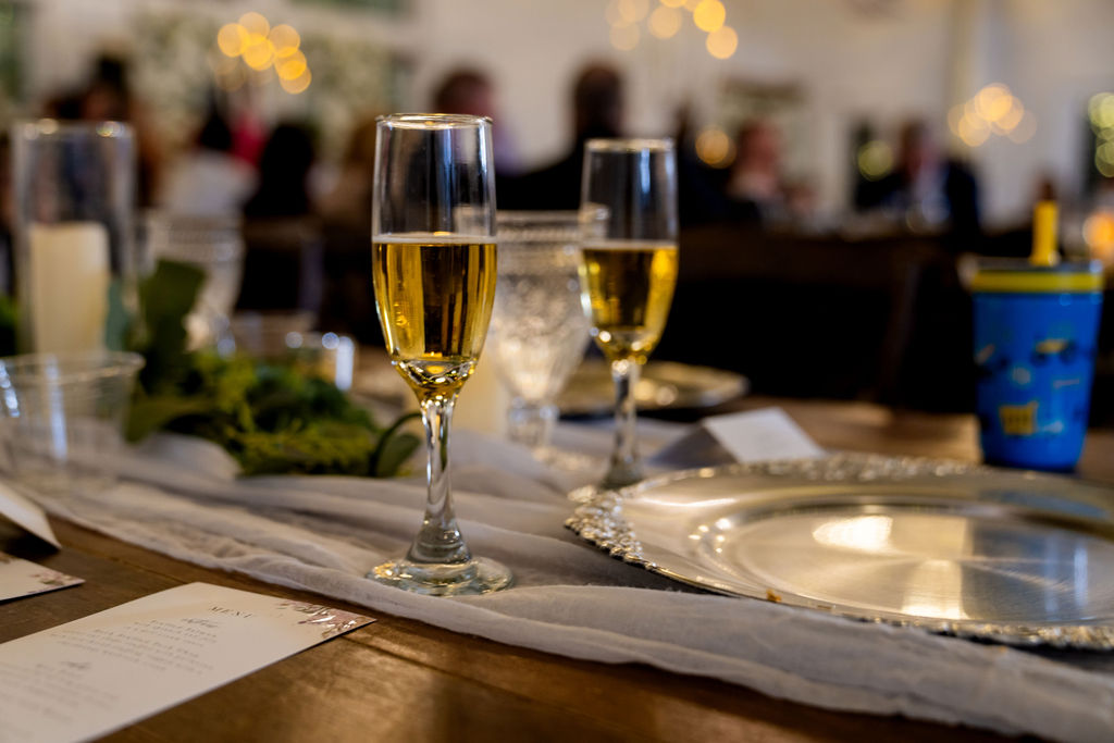 Two champagne flutes on an elegant wedding reception table