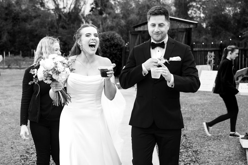 Bride and groom laughing together in a black-and-white wedding portrait