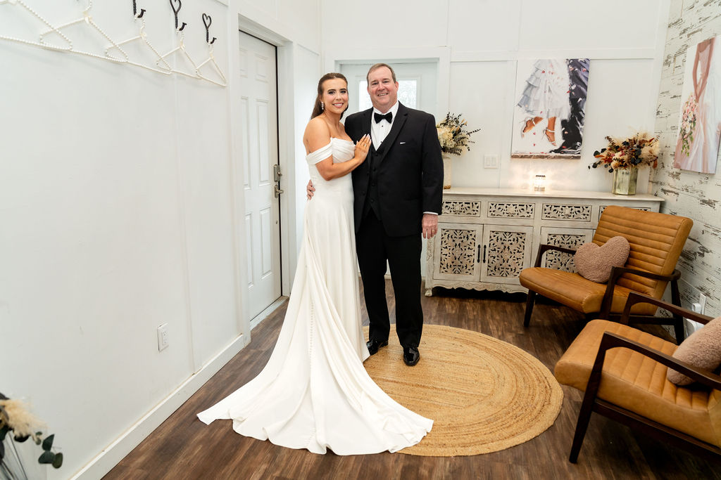 Bride posing with her father after their first look