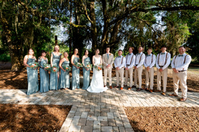 Bride and Groom posing with wedding party at Ever After Farms Blueberry Barn in Mims, Florida. Photo by Pixel Groves.