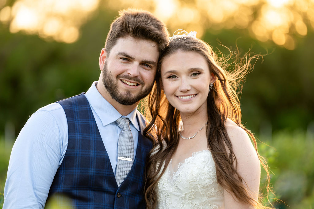 Close portrait of bride and groom in golden sunset light