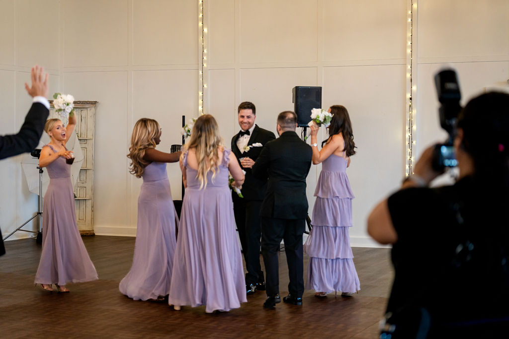 Wedding party cheering during the reception entrance