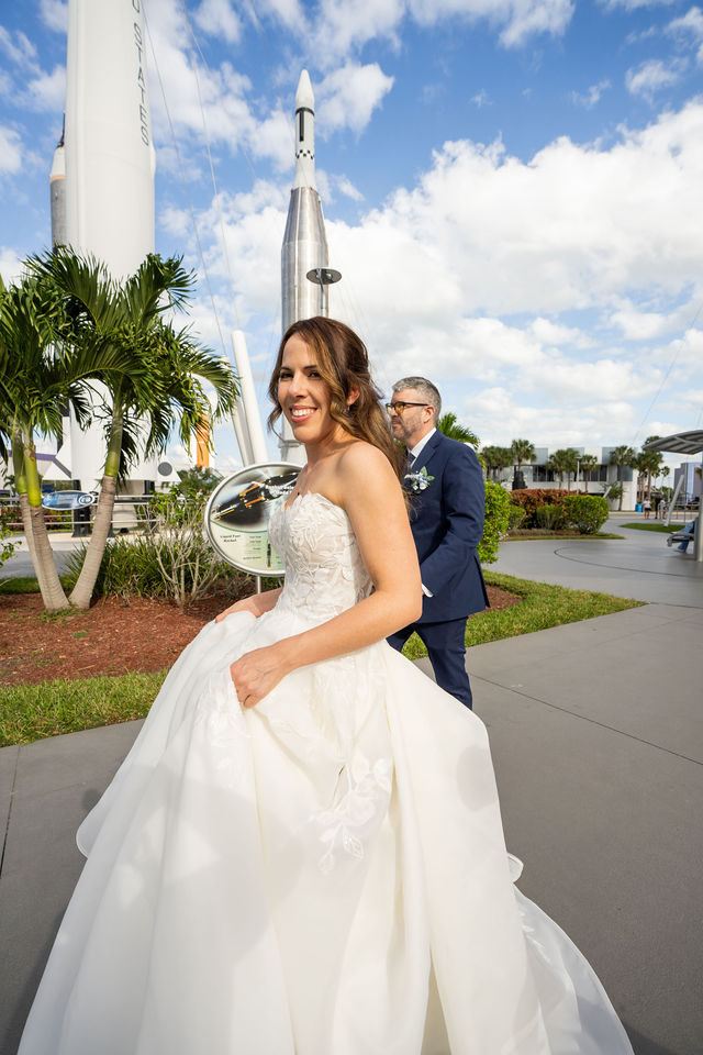 Bride turning toward the camera while walking through a rocket garden