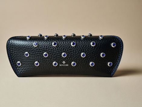 Blue rhinestone studded glasses case in black Florentine pebble grained leather with cobalt blue hand-stitching