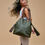 Thumbnail: Bouclier Safari Tote in olive box calf with buffalo leather and stone-inlaid tassels