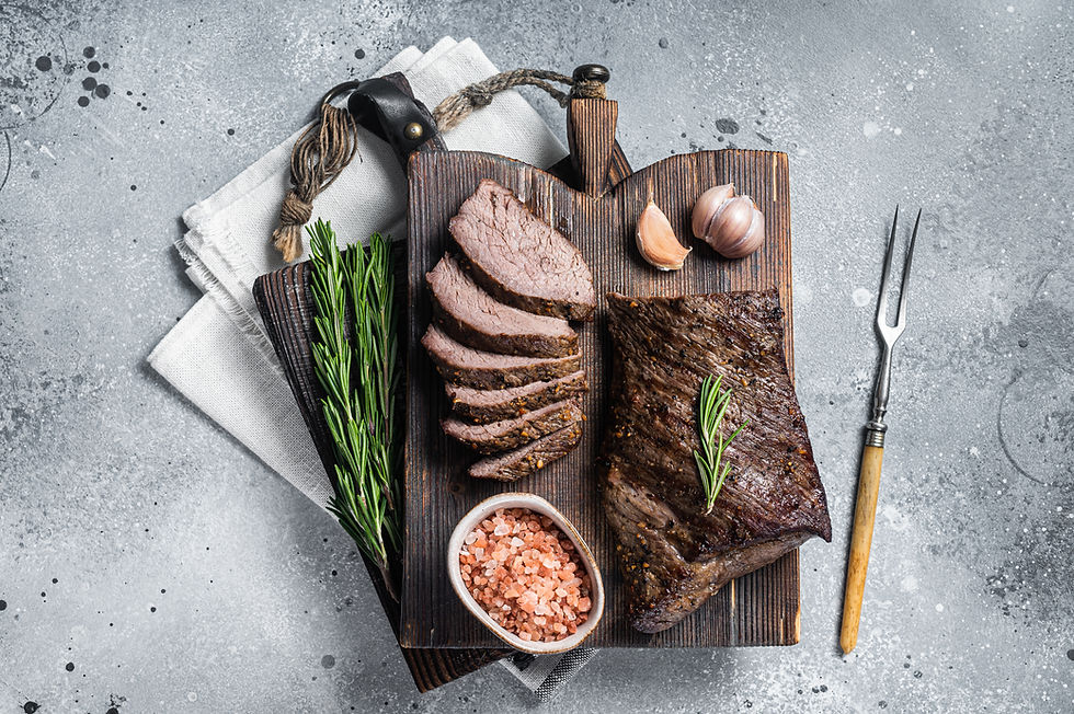 Roast and Sliced Tri Tip Beef Steak On A Wooden Board
