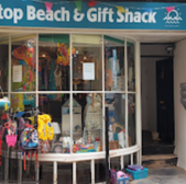 Shopfront of the Top Beach & Gift Shack Weymouth with colourful items on display