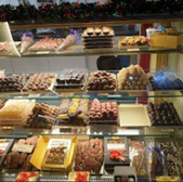 Display case filled with various chocolates and sweets for sale.