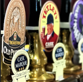 Various beer tap handles with Tetley's, Theakston Old Peculier and Cask Marque logos.