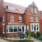 Exterior shot of Grosvenor pub with visible signage and brick building
