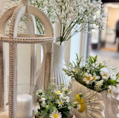 White flowers in vases and lantern; interior decoration, floral arrangement.