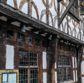 Exterior of classic building with visible windows and timber frame.