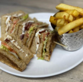 A sandwich with a side order of fries on a white plate