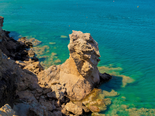 Beautiful shoreline view of turquoise water and rocky terrain