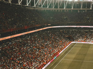 A packed sports stadium filled with spectators