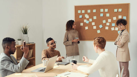 A team of marketing professionals discussing their keyword strategy for Answer Engine Optimization (AEO)