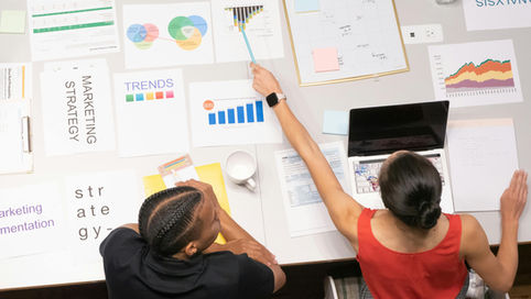 Woman in Red Top Pointing to the topic coverage Graph