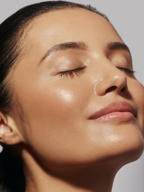 Woman with glowing radiant skin after microneedling treatment in Atlanta.