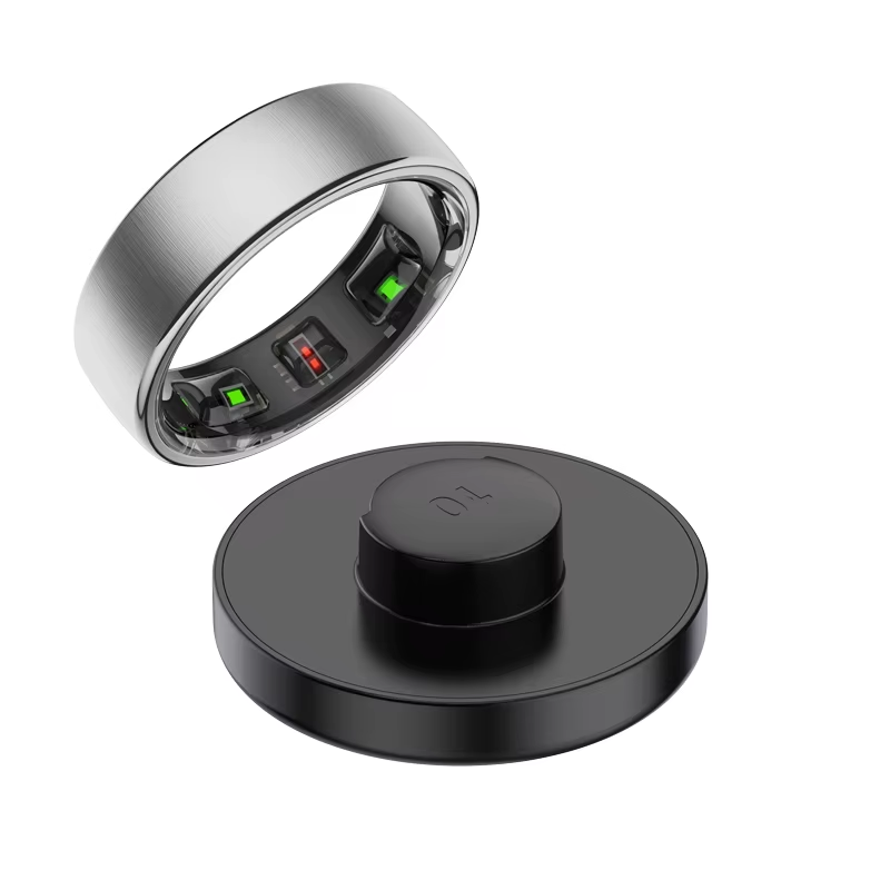 Silver smart ring with internal sensors and black charging dock