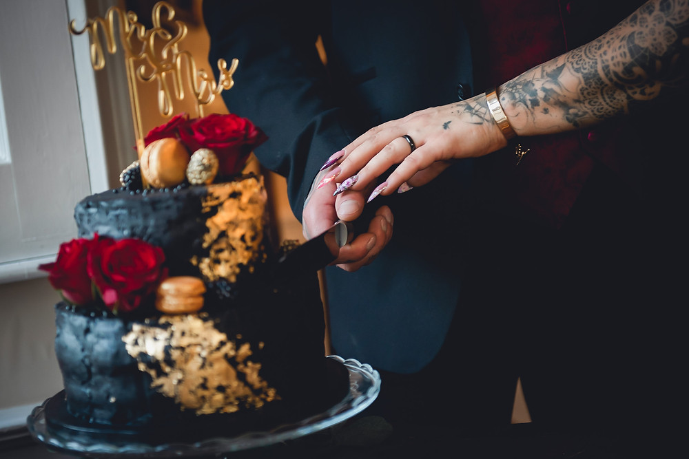 Hands Cutting the Wedding Cake