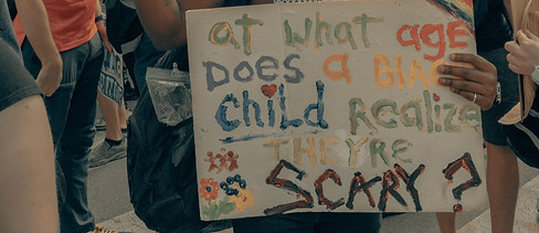 A man holds up a sign at the Black Lives