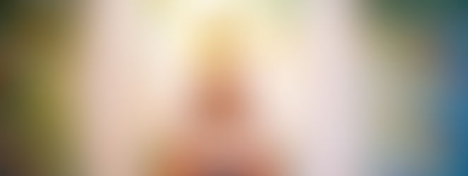 A statue of the Buddha in front of a colourful background