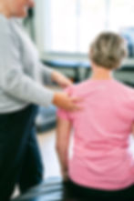 Cancer survivor performing supervised exercise with a Cancer Exercise Specialist as part of a personalized rehab program.