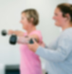 Patient following slow, guided stretches with a Cancer Exercise Specialist to relieve tension after cancer treatment.