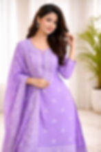Woman wearing a purple Kurti pant dupatta set with intricate embroidery details.