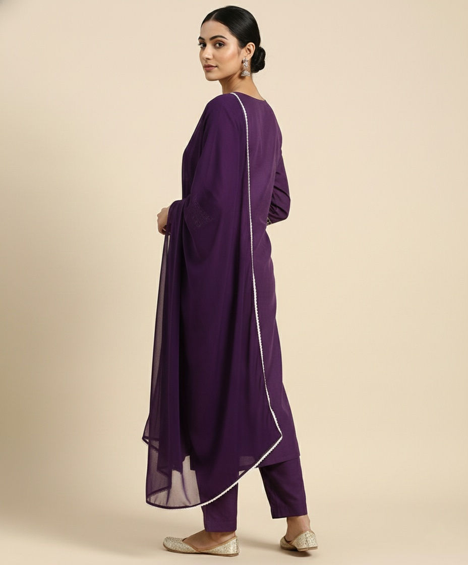 Thumbnail: Elegant woman in a purple Women’s Festive Embroidered Kurta Set with Dhoti Pant & Dupatta, standing side view