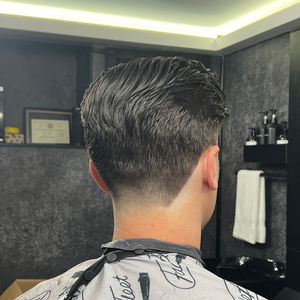 The Gentleman's Low Taper Fade showcases our barbers' expertise in creating modern and sophisticated low taper fade haircuts for men. From clean lines to seamless blending, this haircut highlights our dedication to providing high-quality grooming services for today's modern gentleman.
